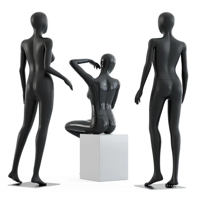 Two female mannequins stand and one sits on a white square stool 58 — Descargar